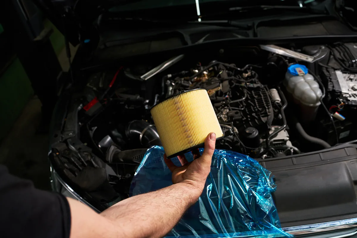 Mechanic inspecting an engine air filter