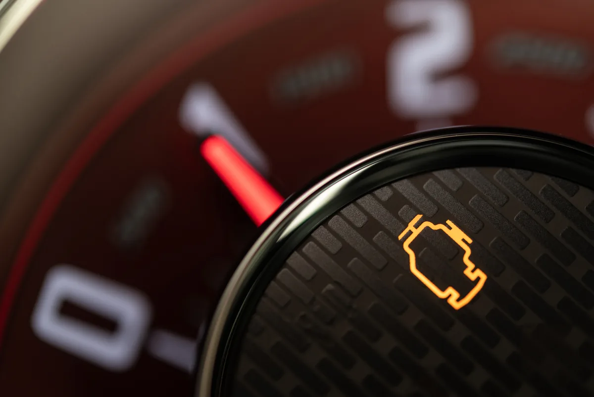 Illuminated engine management light on a car dashboard