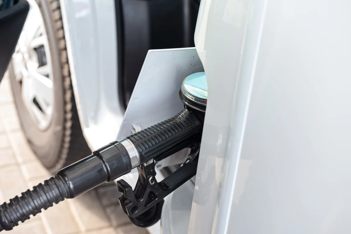 Fuel nozzle inserted into a car filler neck during refuelling