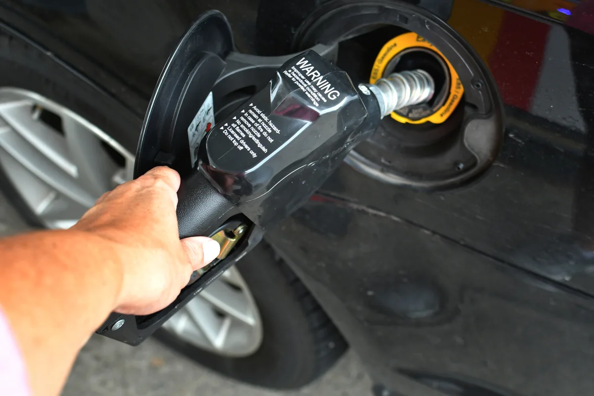 Filling a car fuel tank at a petrol station